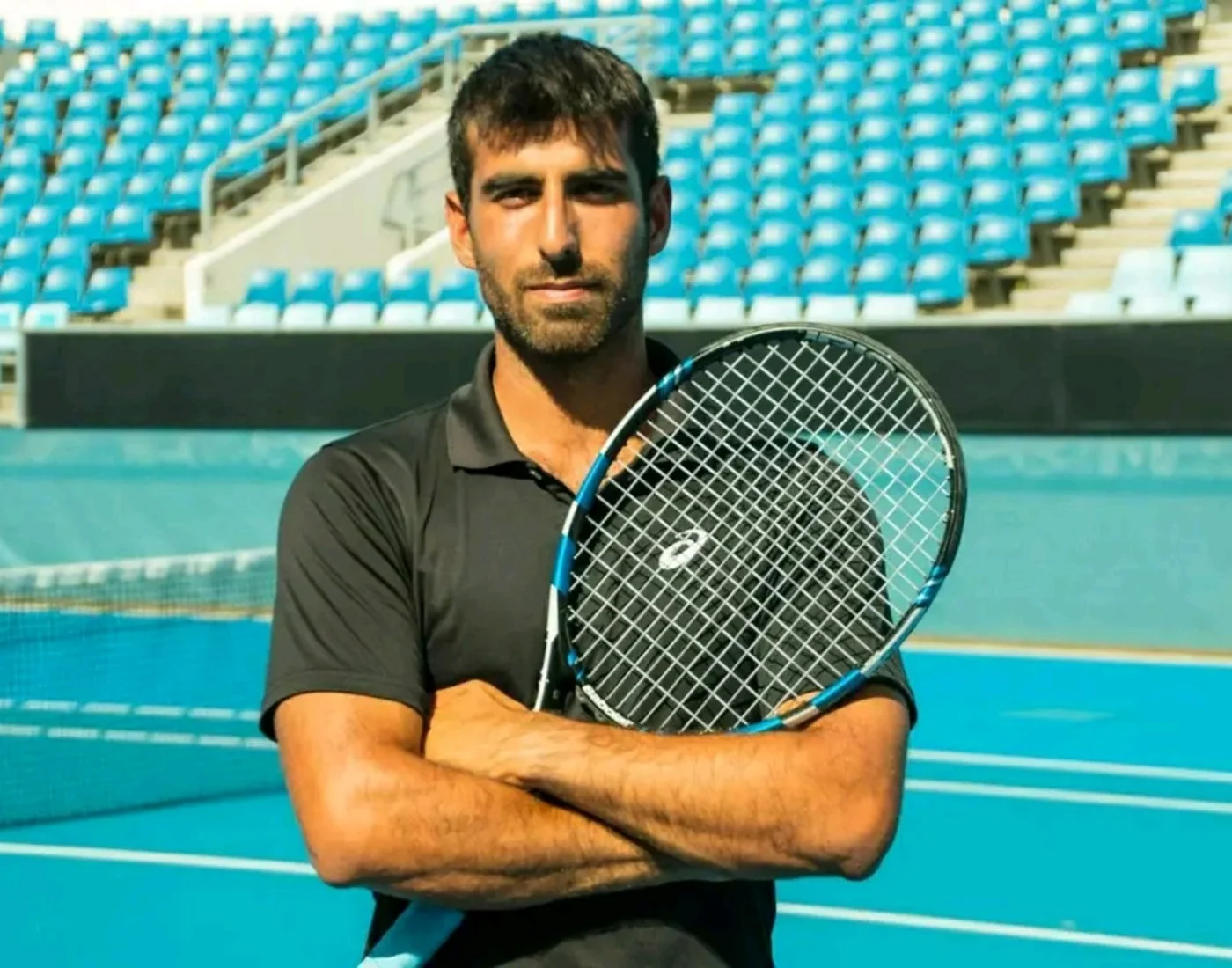 Coach Andy Gomez on an international tennis court